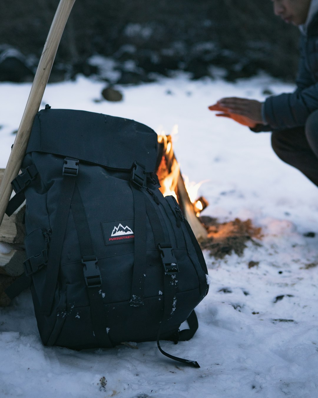 black and gray backpack on white snow covered ground