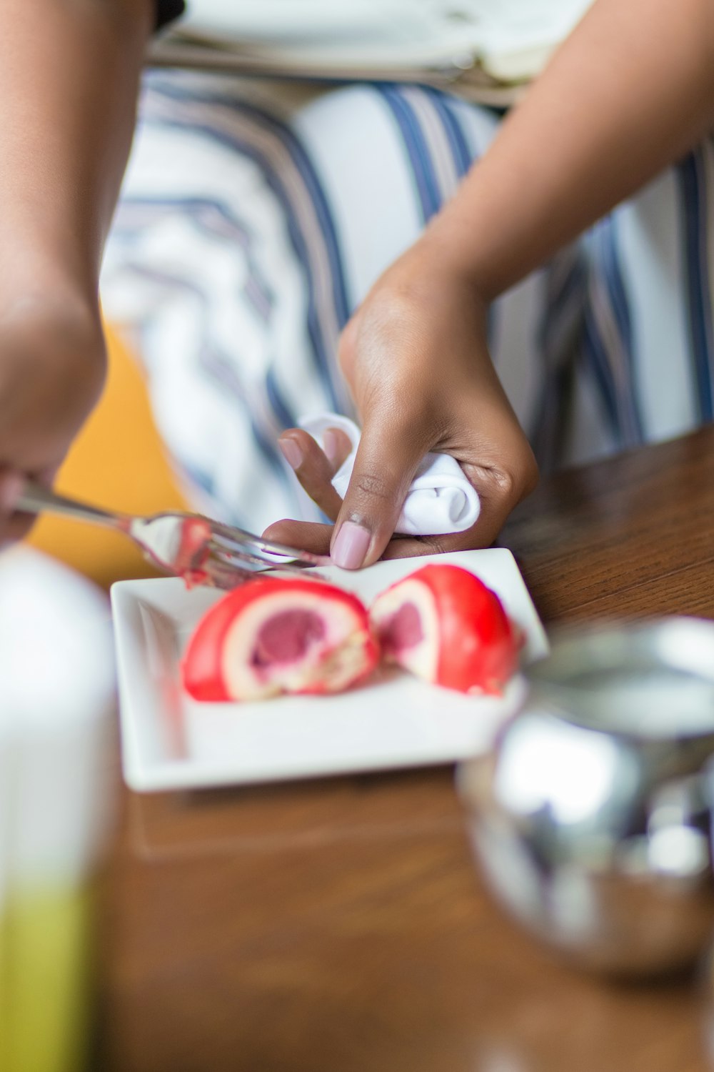 person in white shirt holding red paint brush