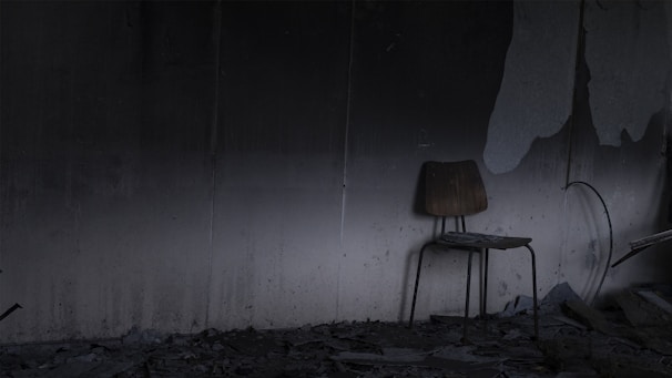 An abandoned chair in a forgotten space.