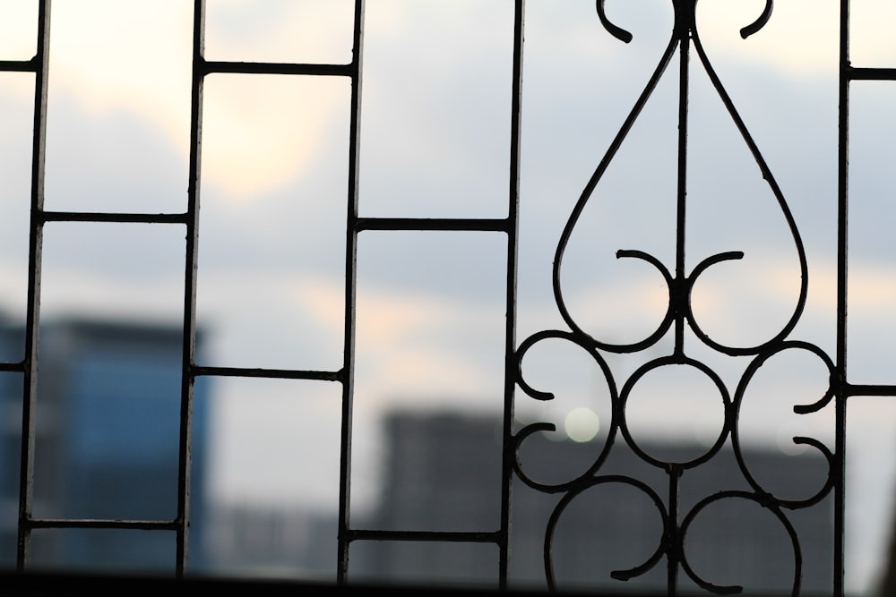black metal window grill during sunset