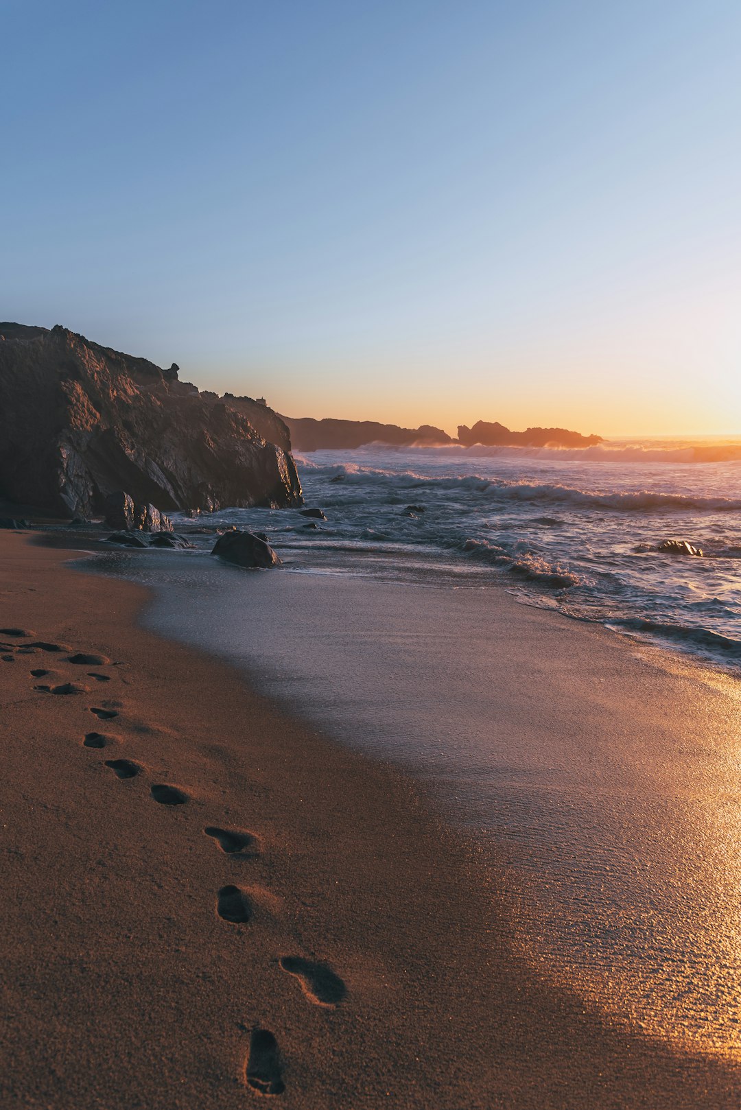 brown sand beach during sunset