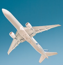 white airplane under blue sky during daytime