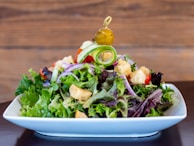 vegetable salad on white ceramic bowl