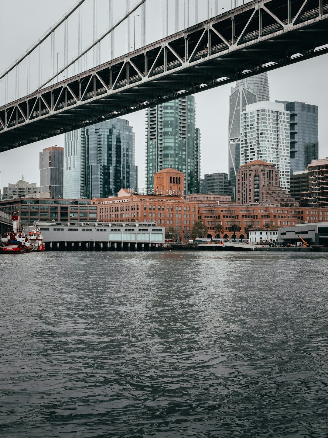 white and red boat on water near bridge during daytime