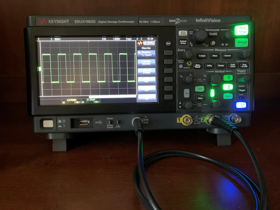 Close-up of a high-precision oscilloscope displaying signal waveforms during testing