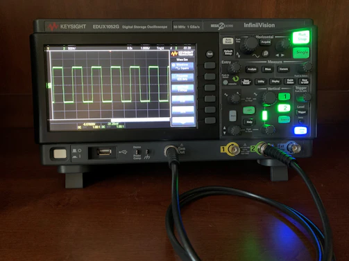 A sleek digital oscilloscope displaying waveforms in a modern lab setting.