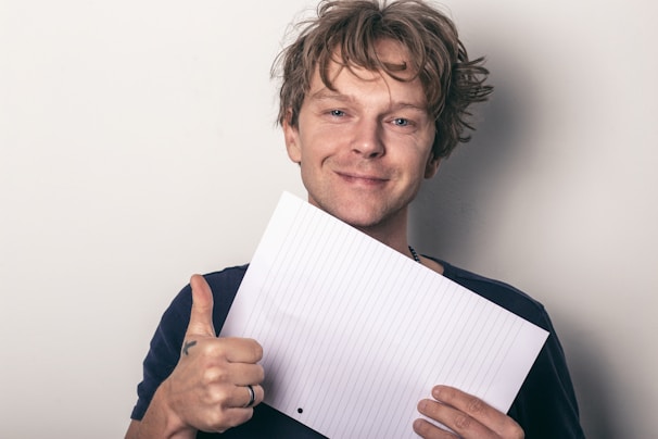 A happy professional holding a printed resume created with Meu Curriculo Rapido.