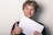 A smiling customer giving a thumbs-up while holding a document.