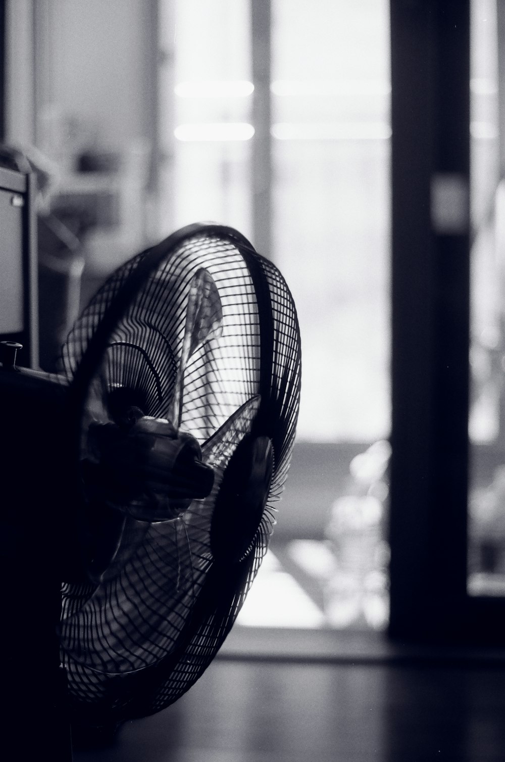 black and white photo of pedestal fan