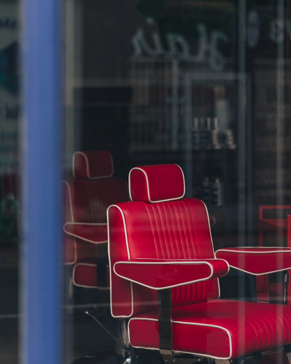 red and white chair near glass window