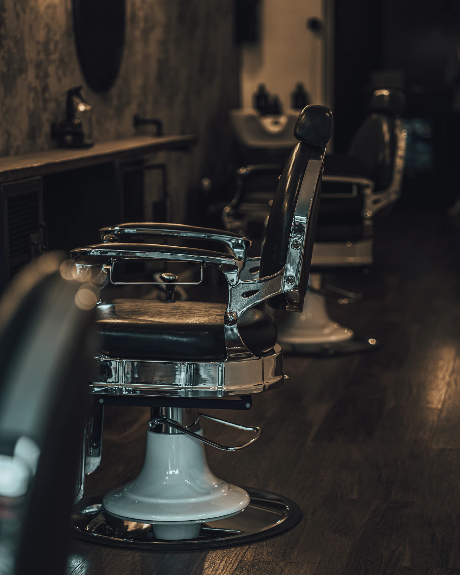 An empty leather barber chair at Tanner & Strop
