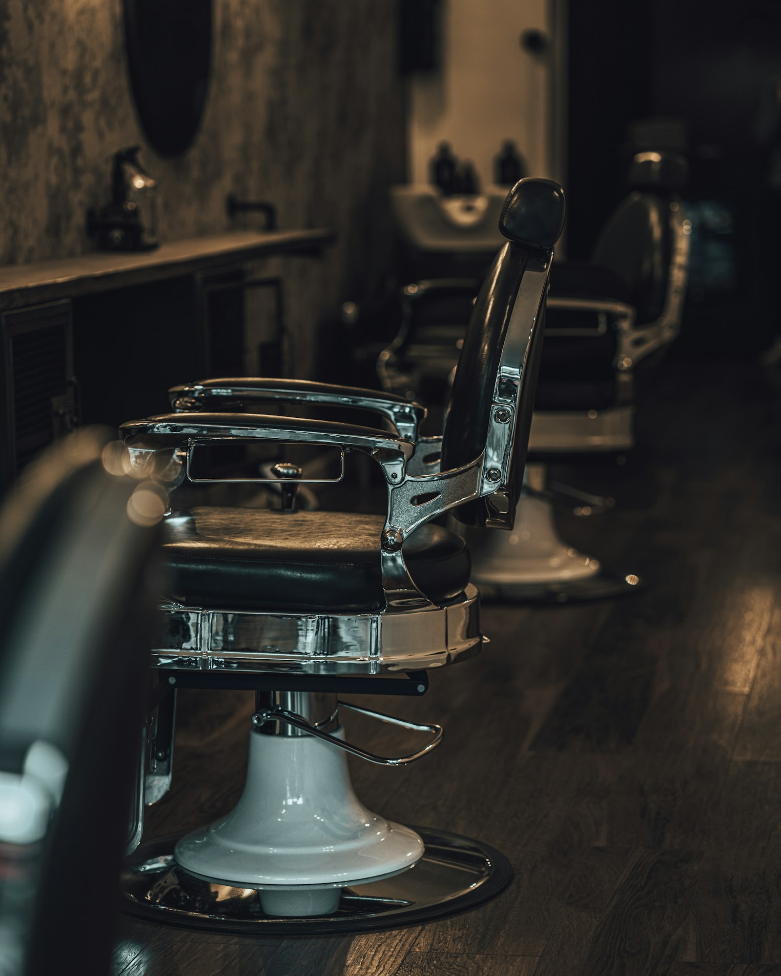 Vintage barber chairs in a moody barbershop interior