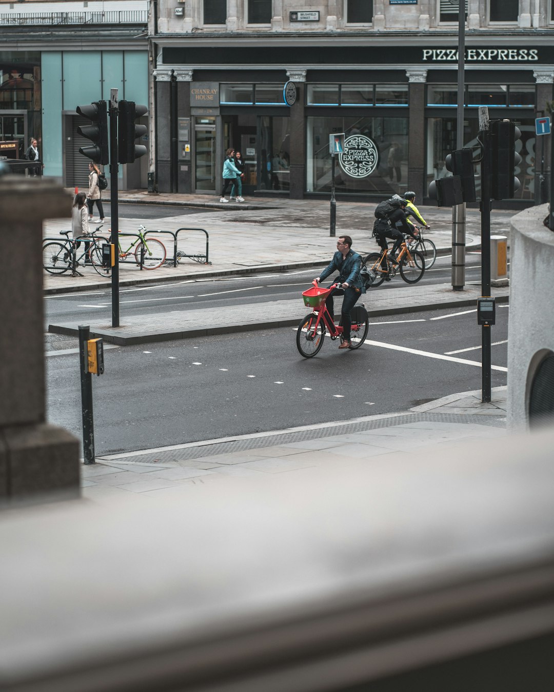 man in blue shirt riding bicycle on road during daytime