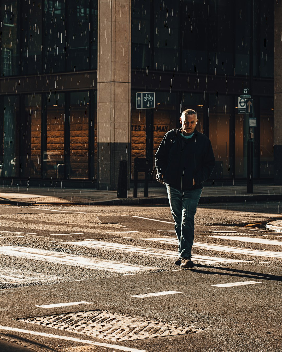 man in black jacket standing on gray concrete road during daytime