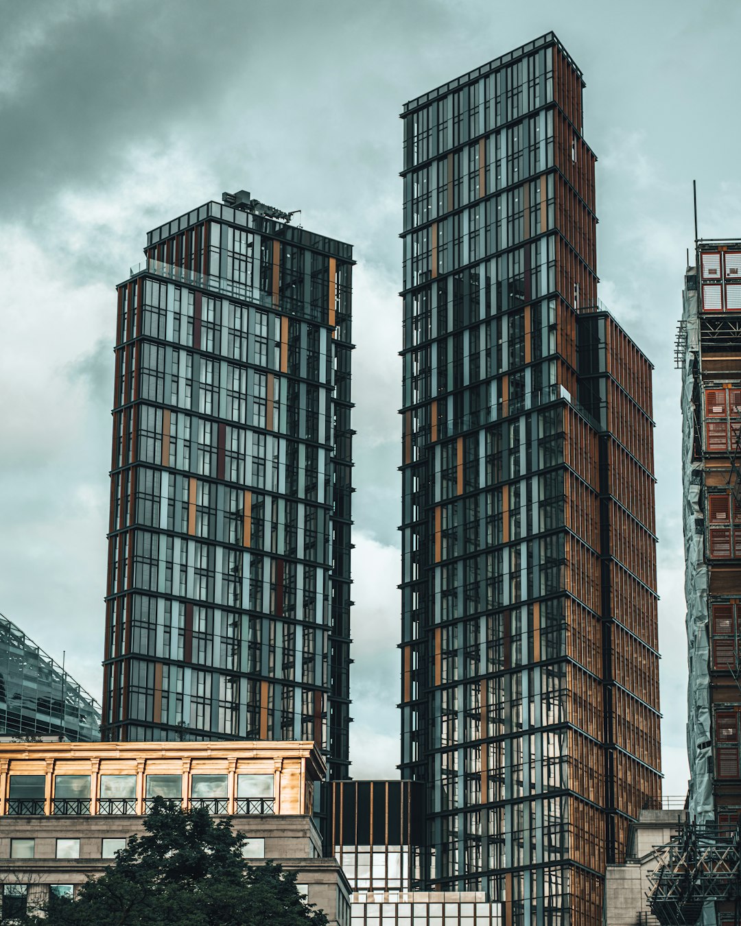 brown and black concrete building under gray clouds