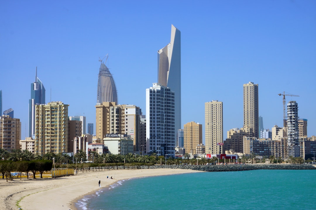 people on beach near high rise buildings during daytime