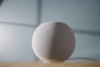 round gray ball on brown wooden table