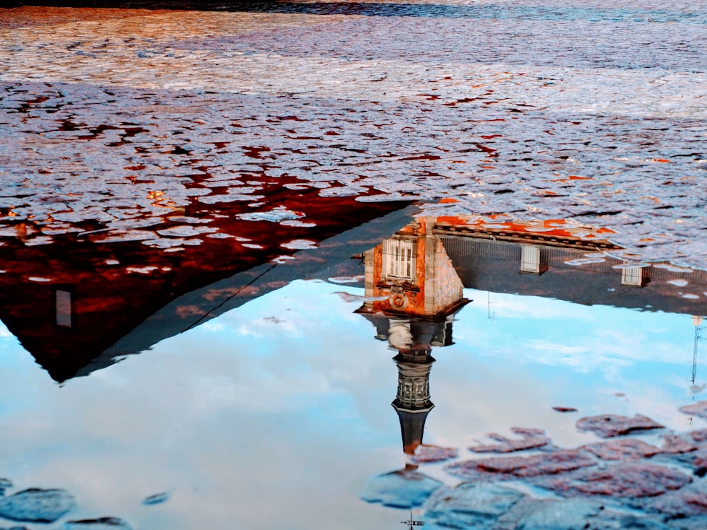 red and white concrete building near body of water during daytime