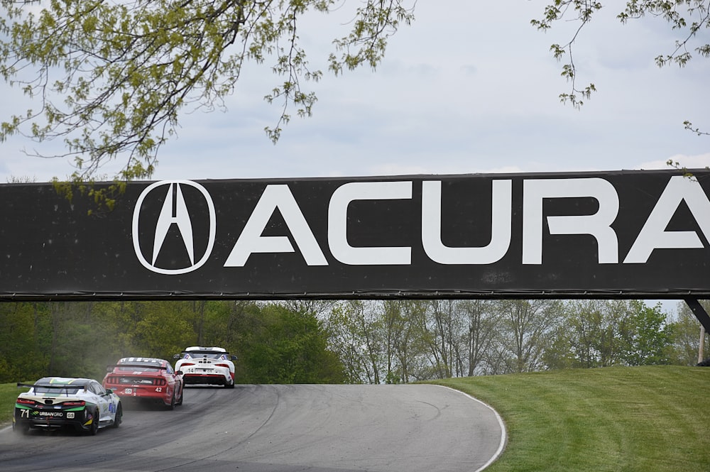 a group of cars driving down a race track