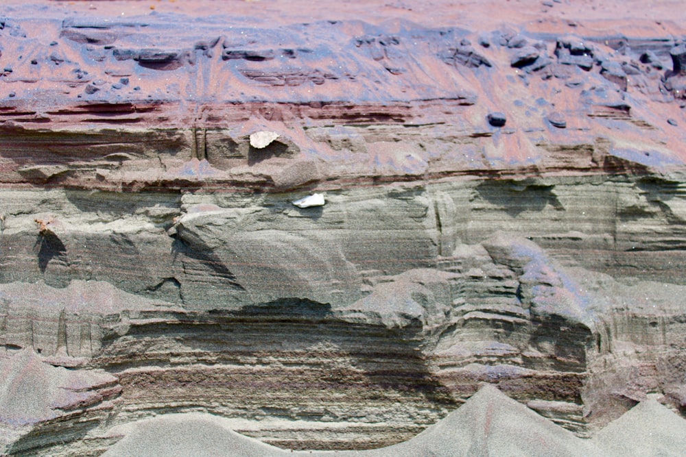 body of water near gray rock formation during daytime