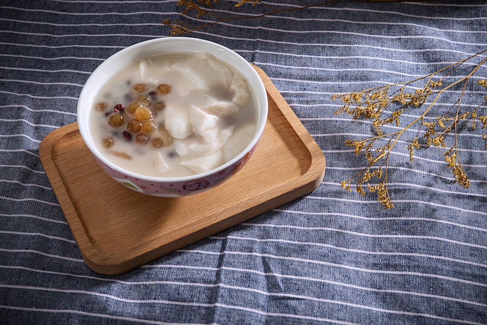 white ceramic bowl on brown wooden chopping board