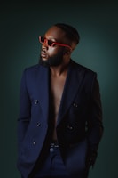 A close-up of a man wearing a sleek navy blazer from the men's collection.