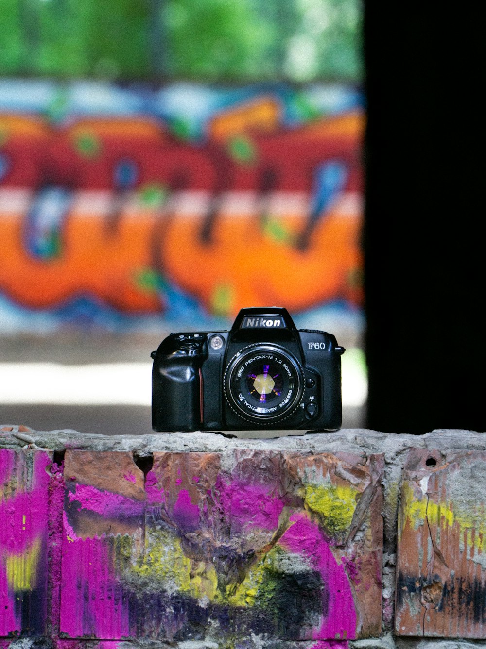 black nikon dslr camera on brown wooden table