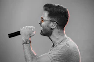 A dynamic shot of a rapper mid-verse, with expressive hand gestures and intense focus.