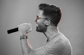 A dynamic shot of a rapper mid-verse, with expressive hand gestures and intense focus.