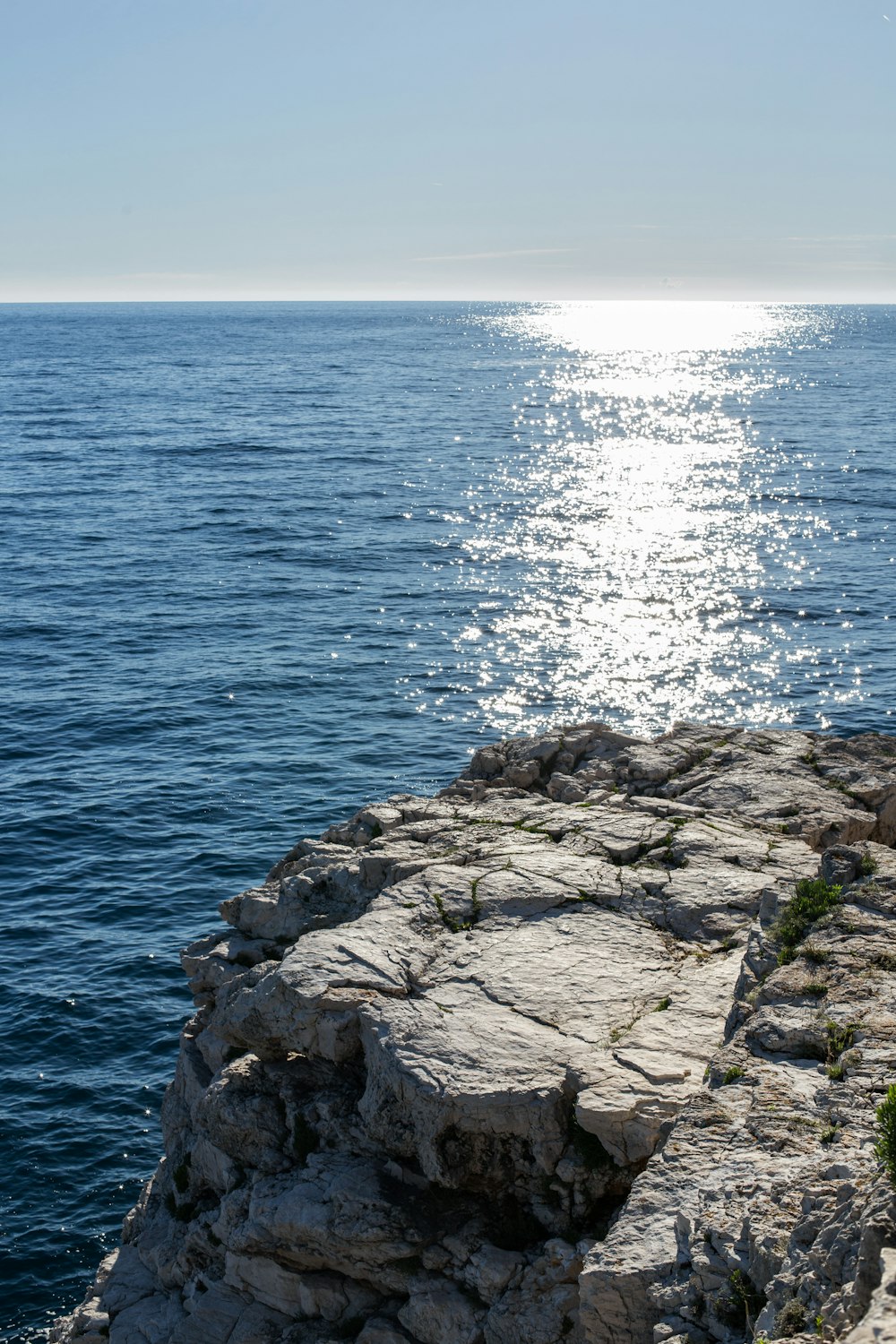 rocky shore with sea waves crashing on rocks during daytime