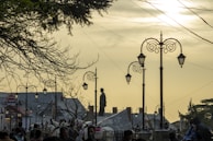 Evening shot of the stable lit with warm lights, people dancing and art exhibits glowing.