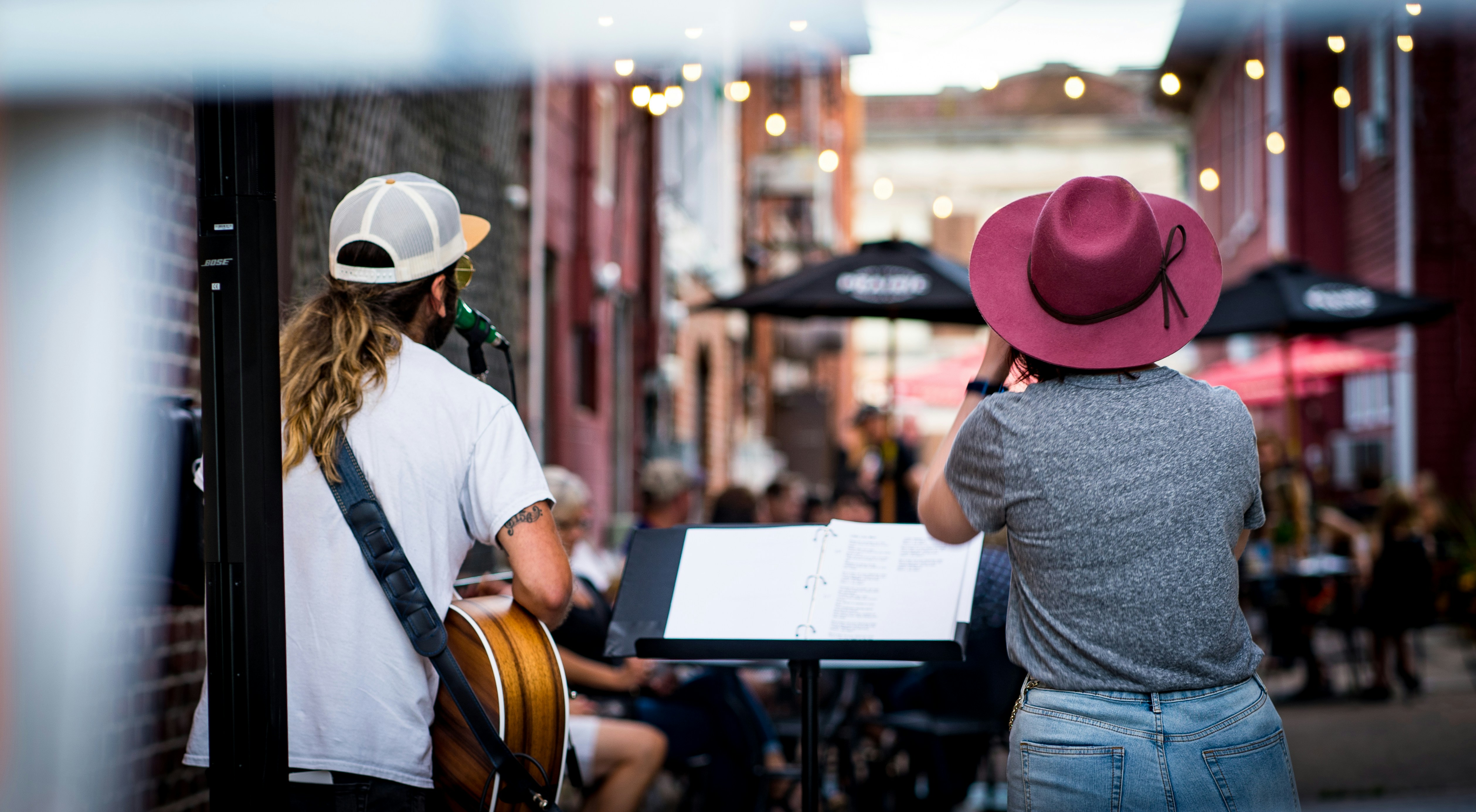 man in white dress shirt and blue denim jeans standing beside man in white dress shirt