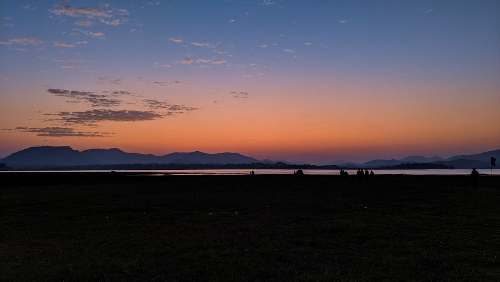 silhouette of people on beach during sunset