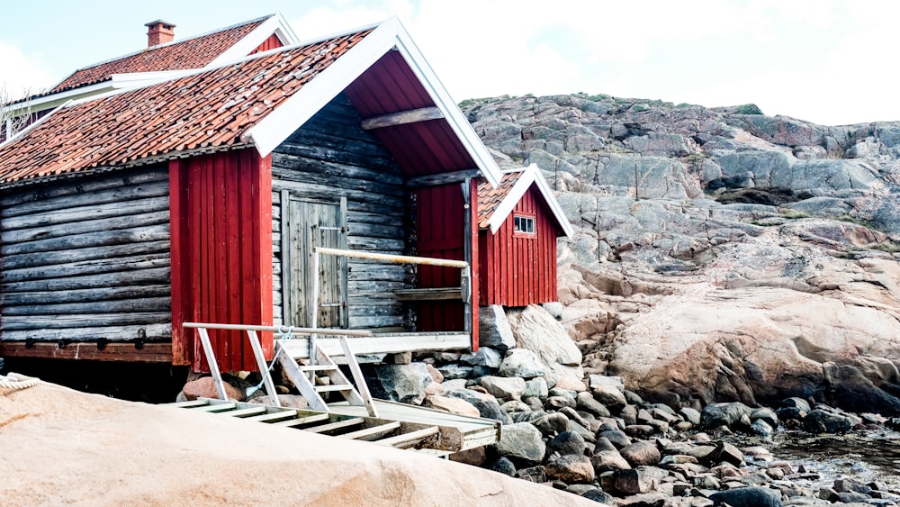 red wooden house near brown rocks