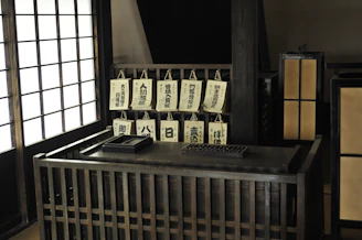 A calm, minimalist classroom setting with Japanese language learning materials on a wooden desk.