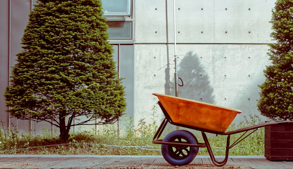 brown and black wheel barrow on gray concrete road