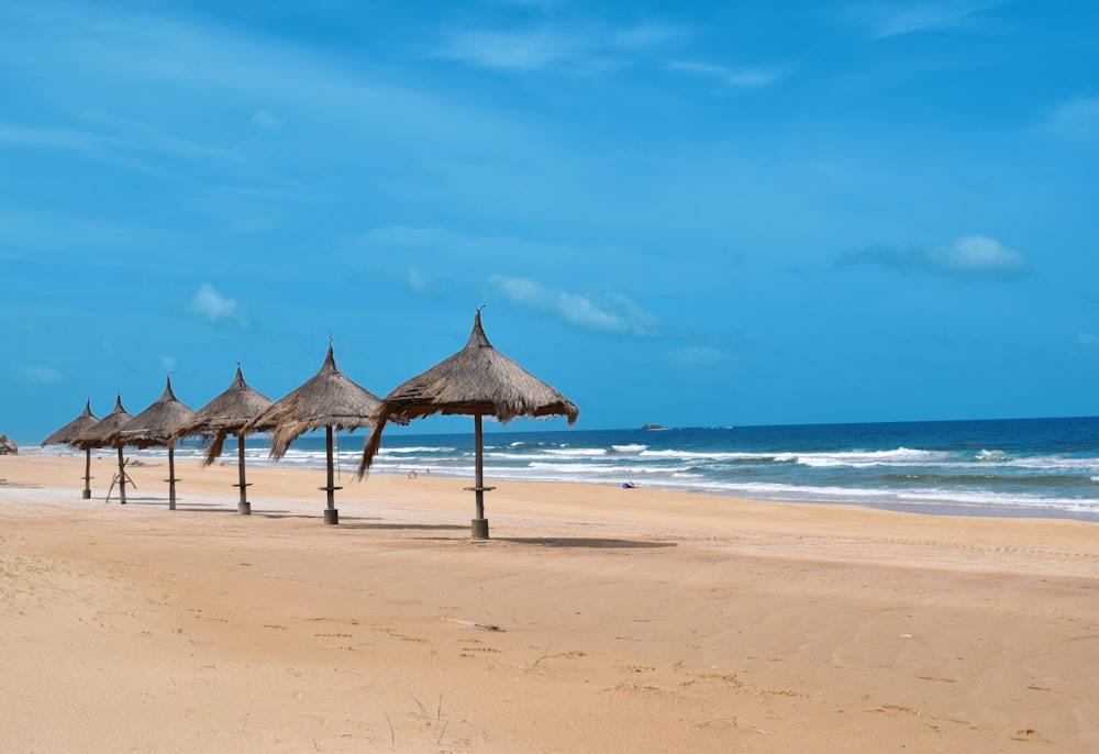 brown beach umbrella on beach during daytime