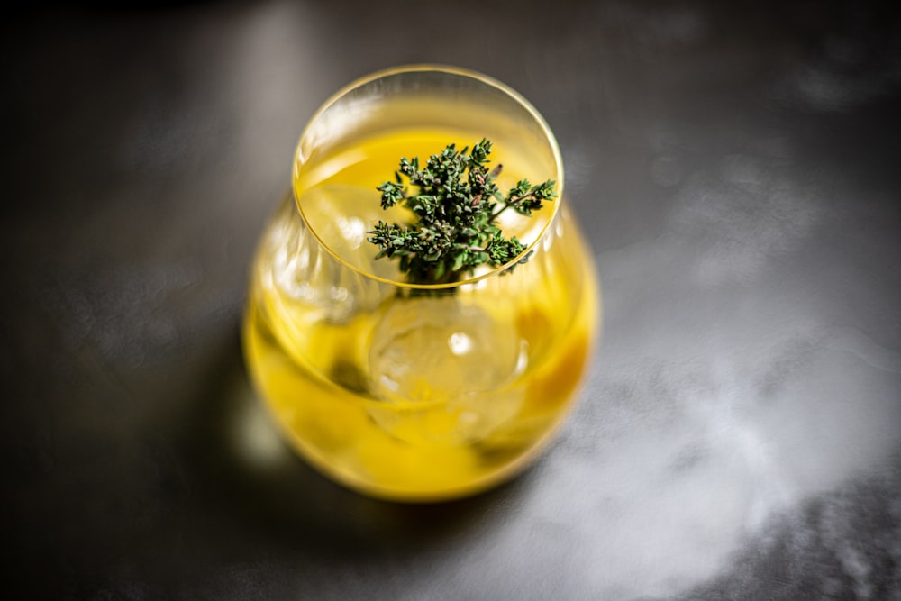 clear drinking glass with yellow liquid