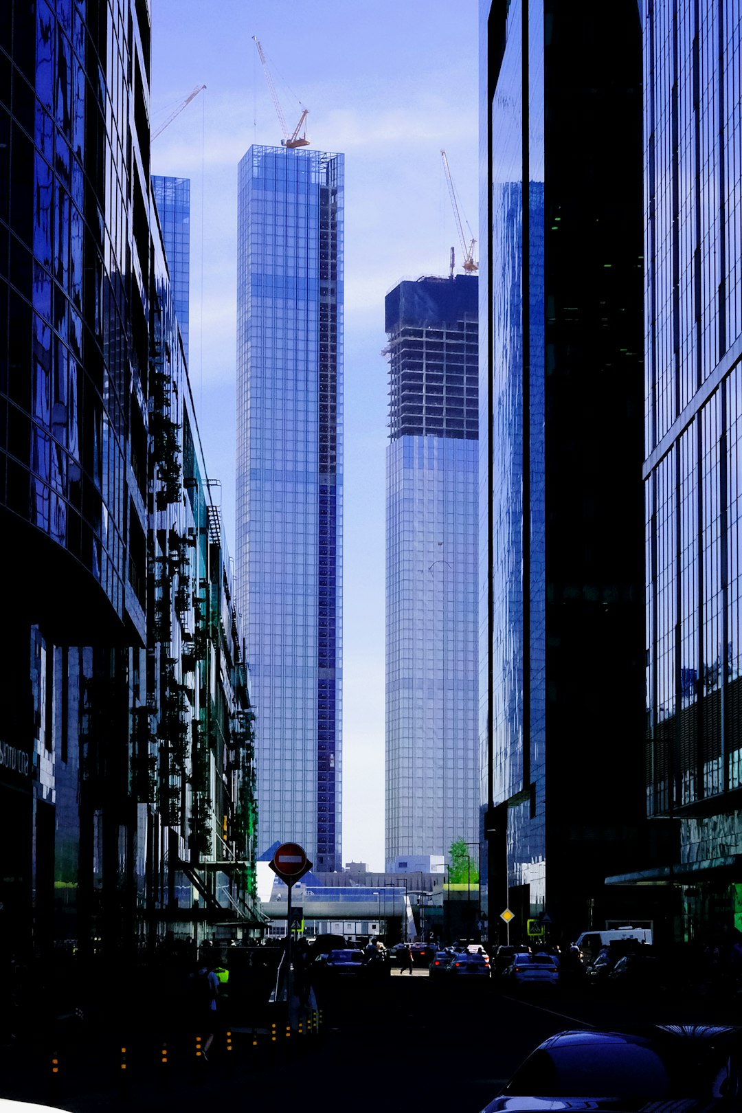 people walking on sidewalk near high rise buildings during daytime