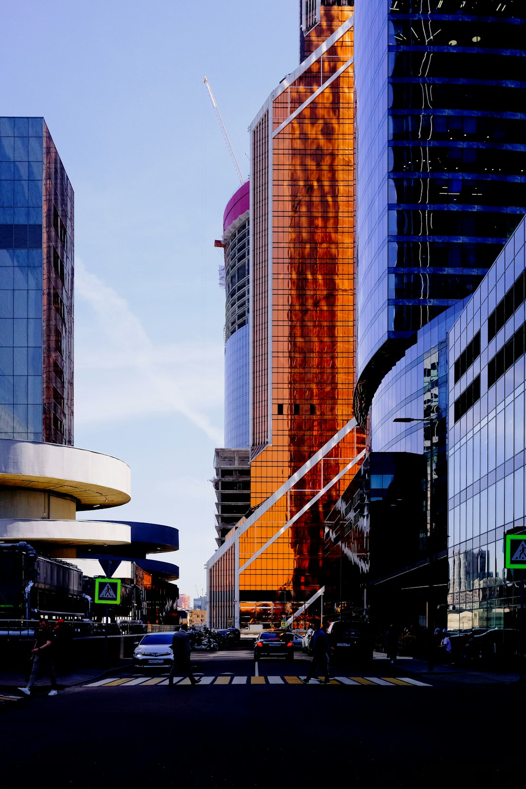 cars on road near high rise buildings during daytime