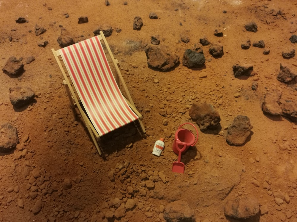 red and white striped folding bed on brown sand