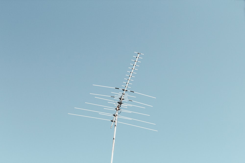 black electric post under blue sky during daytime