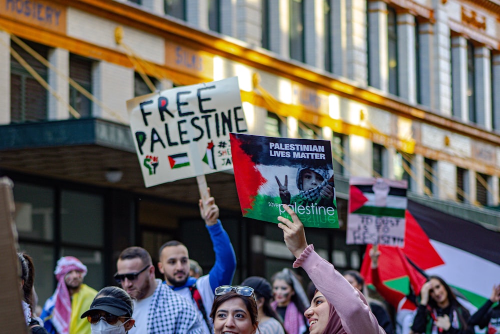 people holding white and red banner during daytime