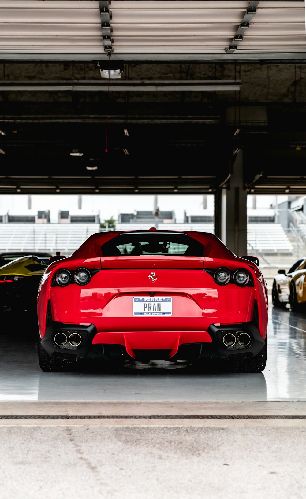 red ferrari car in a parking lot