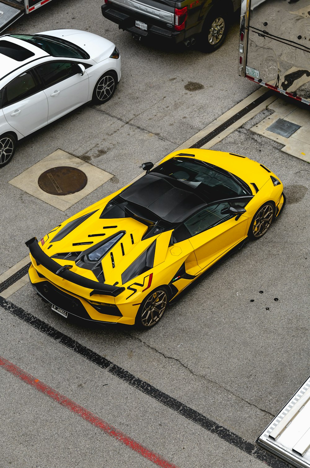 yellow lamborghini aventador parked on parking lot during daytime