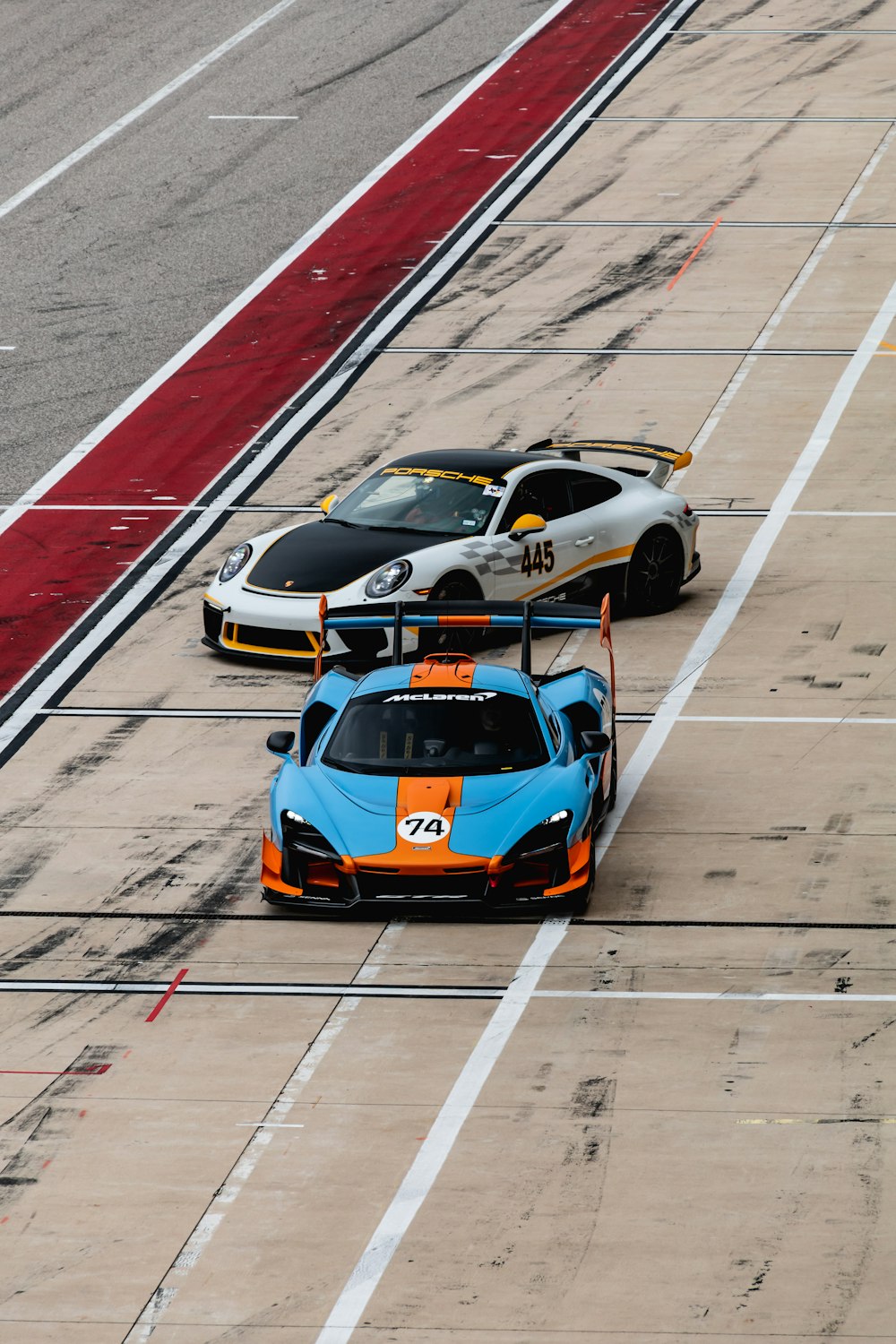 two race cars driving on a race track