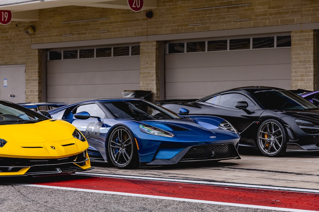 blue and yellow lamborghini aventador parked near white building