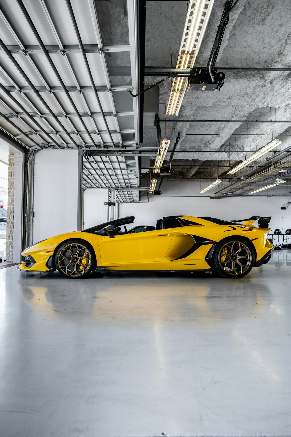 yellow ferrari 458 italia parked inside building