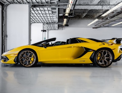 yellow ferrari 458 italia parked inside building