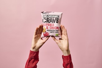 Rows of dried vegetable chips in orange and white packaging featuring the Merivale logo.